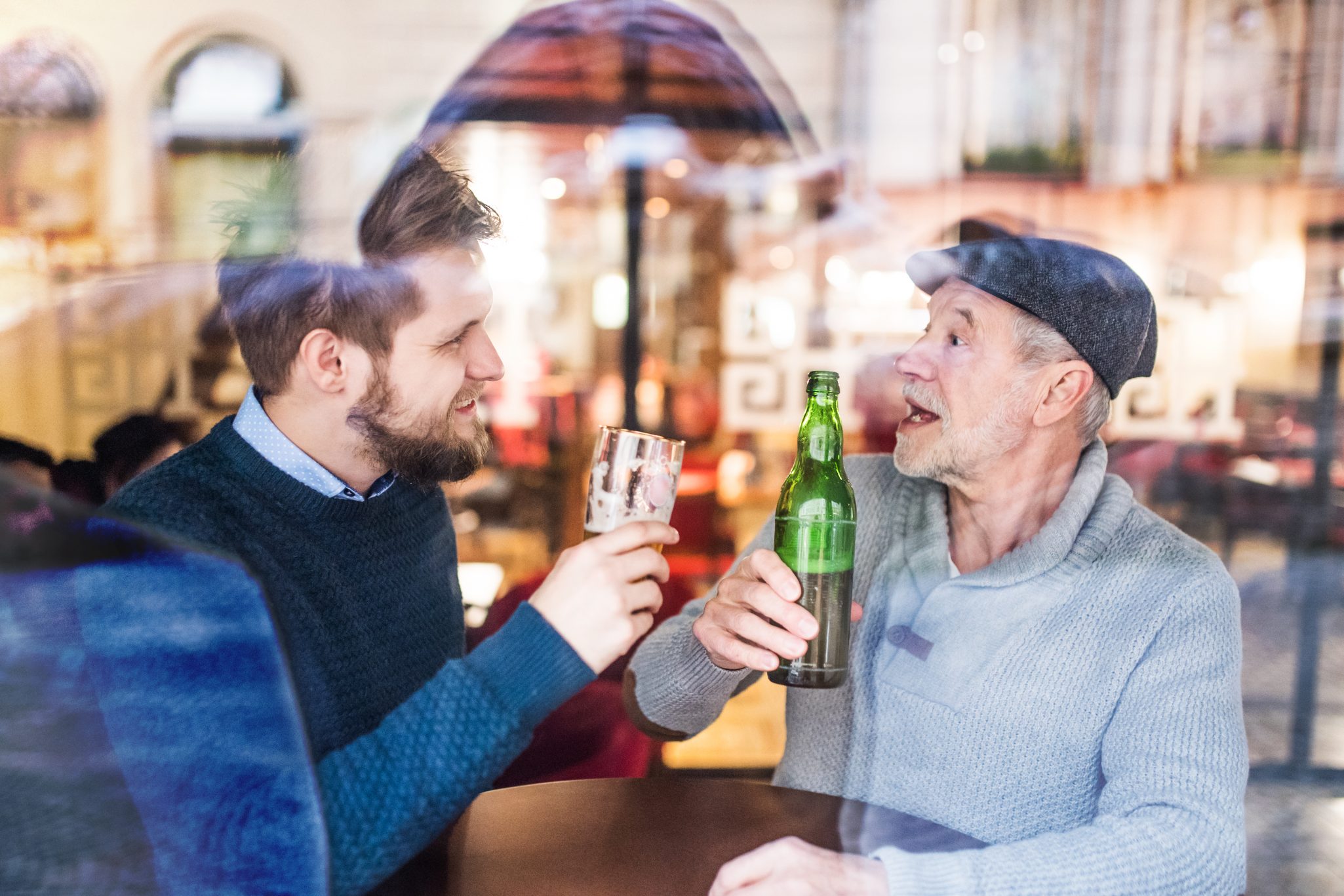 Senior father and his young son in a pub