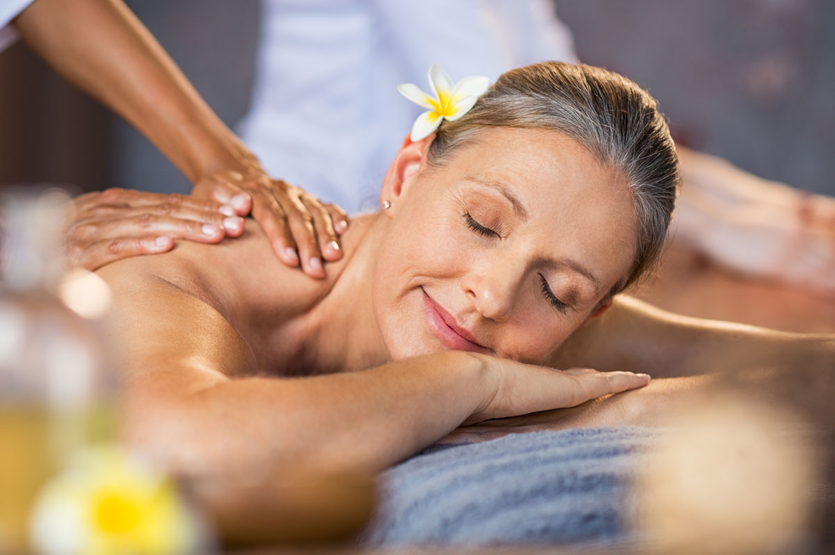 Senior woman getting a massage at a spa